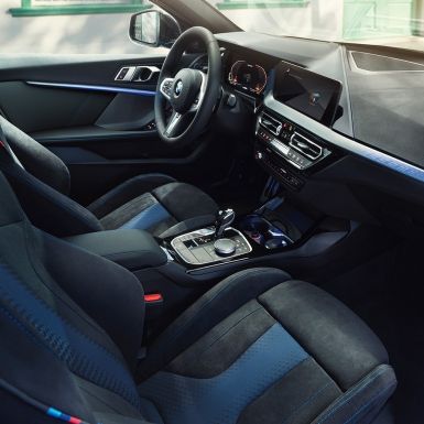 Sporty BMW 1 Series interior F40. BMW 1 Series cockpit with M Sport seats, M Leather steering wheal and illuminated interior trim finishers F40.