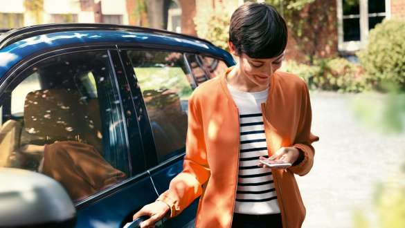 BMW Teleservices BMW Teleservices woman standing in front of a BMW