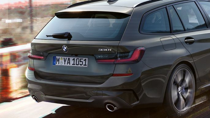 BMW 3 Series Touring, three-quarter rear shot G21 BMW 3 Series Touring, three-quarter rear shot driving on bridge in front of rural surroundings G21