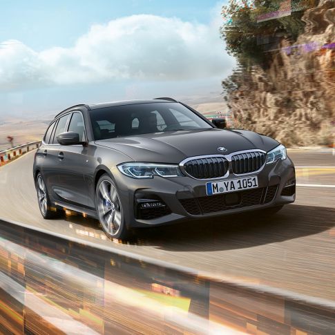 BMW 3 Series Touring, three-quarter front shot design G21 BMW 3 Series Touring, three-quarter front shot driving on bridge in front of rural surroundings G21
