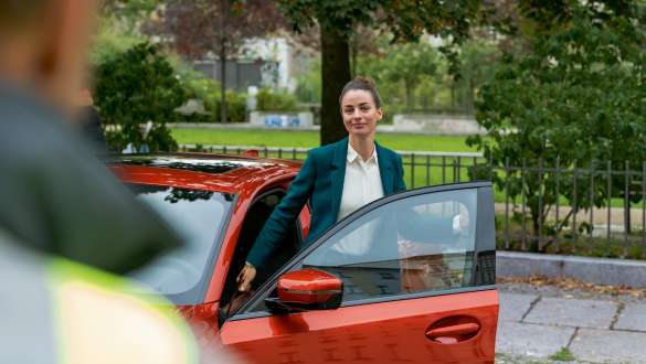 Women standing in the open door of her BMW
Women standing in the open door of her BMW