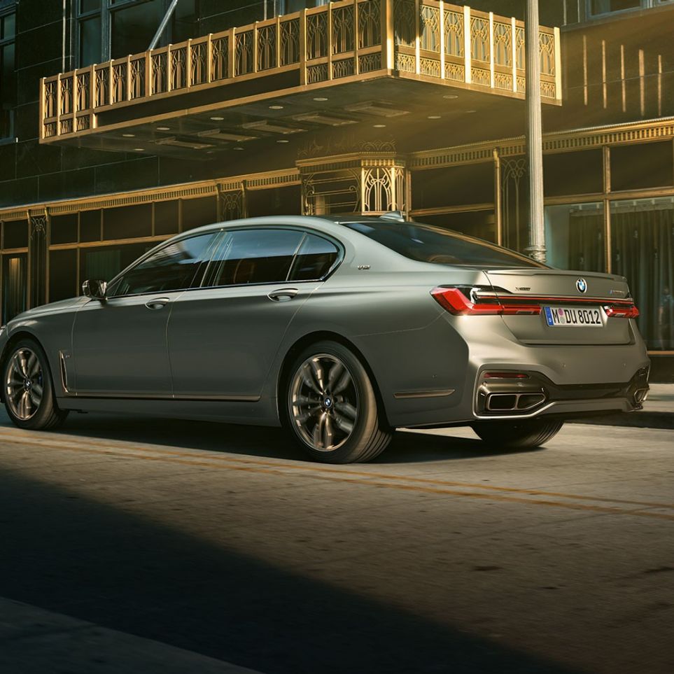 BMW M760Li xDrive with V12 engine 플러그인 하이브리드 G11 BMW M760Li xDrive stands in lateral rear view in front of skyscrapers in urban setting 플러그인 하이브리드 G11