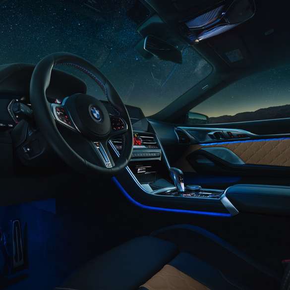 BMW M8 Competition Coupé, cockpit F92. BMW M8 Competition Coupé, cockpit at night with M leather steering wheel and blue ambient light F92.