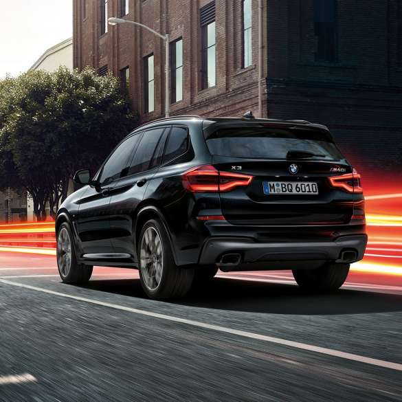 BMW X3 M40i SUV, 후측면 뷰 G01. BMW X3 M40i SUV 블랙 사파이어 메탈릭, 드라이빙, 외관, 도심 속 후측면 뷰 G01.