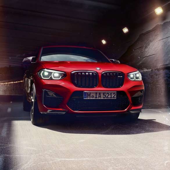 BMW X4 M Competition SUV, front view F98. BMW X4 M Competition SUV in Toronto Red metallic, exterior, front view F98.