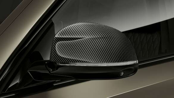 BMW X6 M50i M Carbon mirror caps BMW X6 M50i M50d G06 SUV with close-up on M Carbon mirror caps