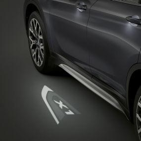 BMW X1 SUV F48, LED-Projection “X1”. BMW X1 SUV F48, side view with focus on LED-Projection “X1”.