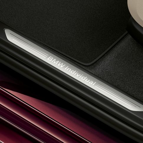Entry sills with BMW individual lettering SUV G07 Close-up of illuminated entry sills with BMW individual lettering SUV G07