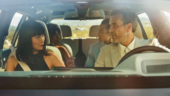 BMW Gesture Control Man and woman are sitting in the car, woman is applying the gesture control
