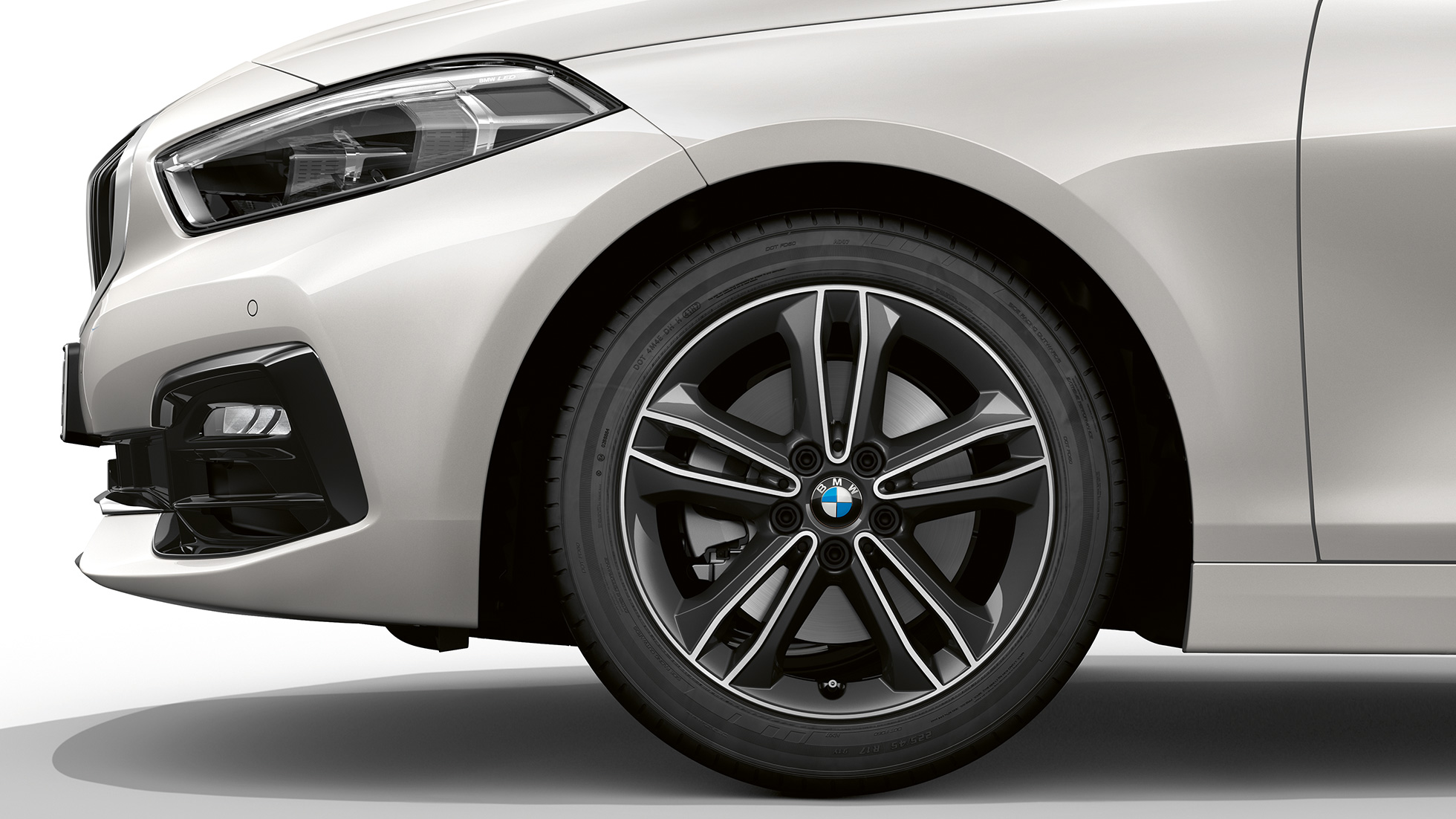 17" light-alloy wheel Double-spoke 549 style F40. BMW 1 Series Model Sport Line in Mineral White metallic, side view of front with 17'' light-alloy wheel Double-spoke 549 style F40.