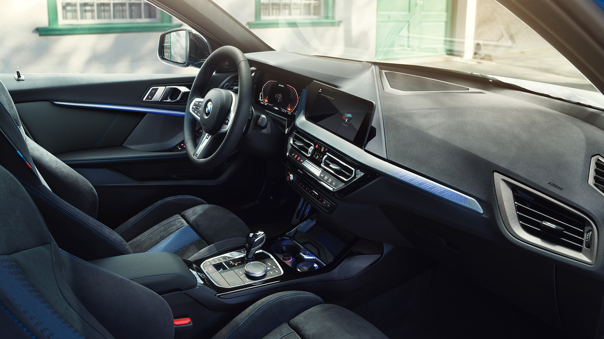 Sporty BMW 1 Series interior F40. BMW 1 Series cockpit with M Sport seats, M Leather steering wheal and illuminated interior trim finishers F40.
