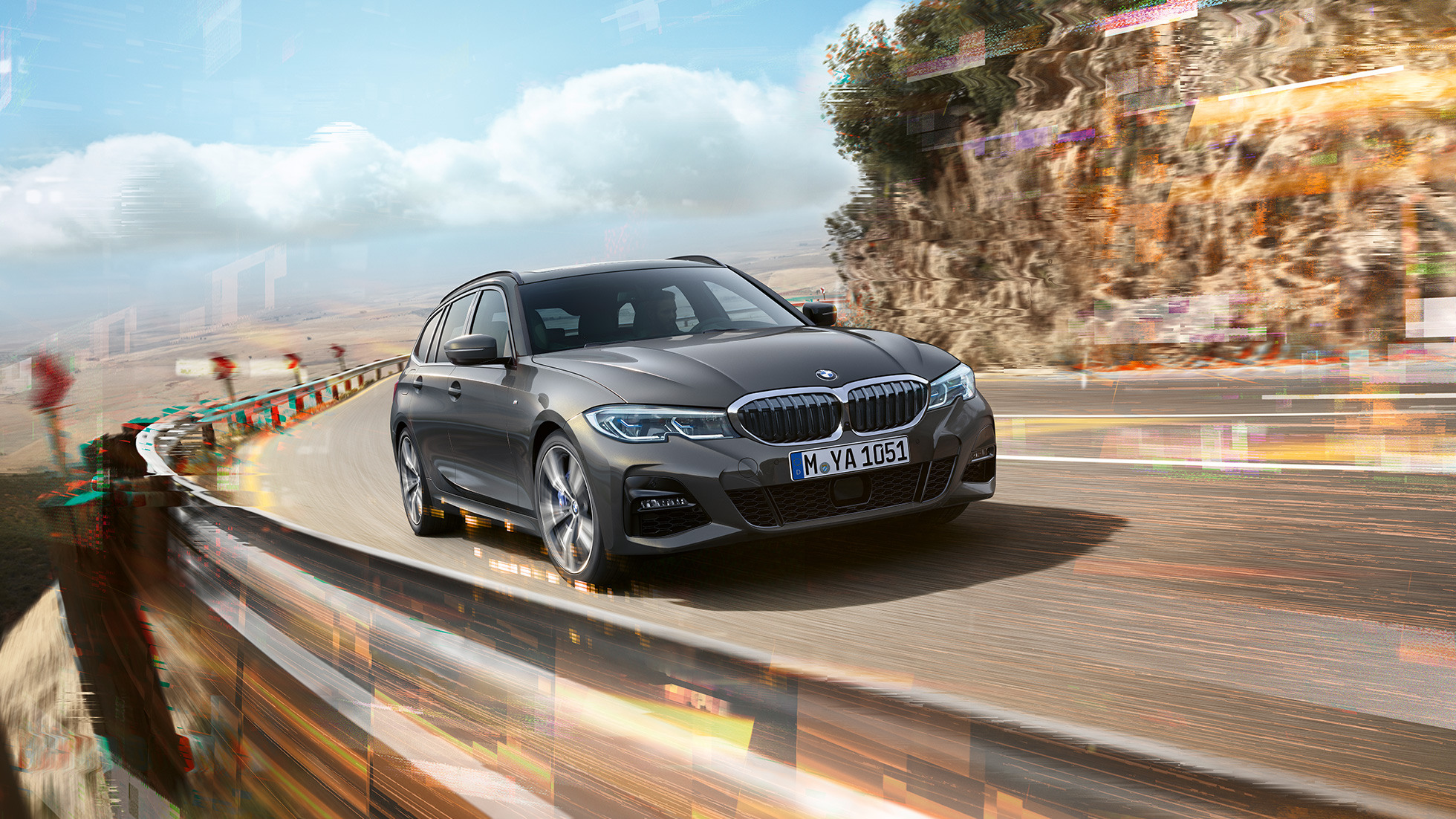 BMW 3 Series Touring, three-quarter front shot design G21 BMW 3 Series Touring, three-quarter front shot driving on bridge in front of rural surroundings G21