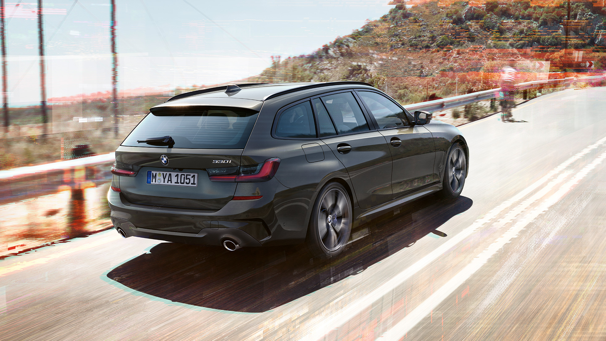 BMW 3 Series Touring, three-quarter rear shot G21 BMW 3 Series Touring, three-quarter rear shot driving on bridge in front of rural surroundings G21