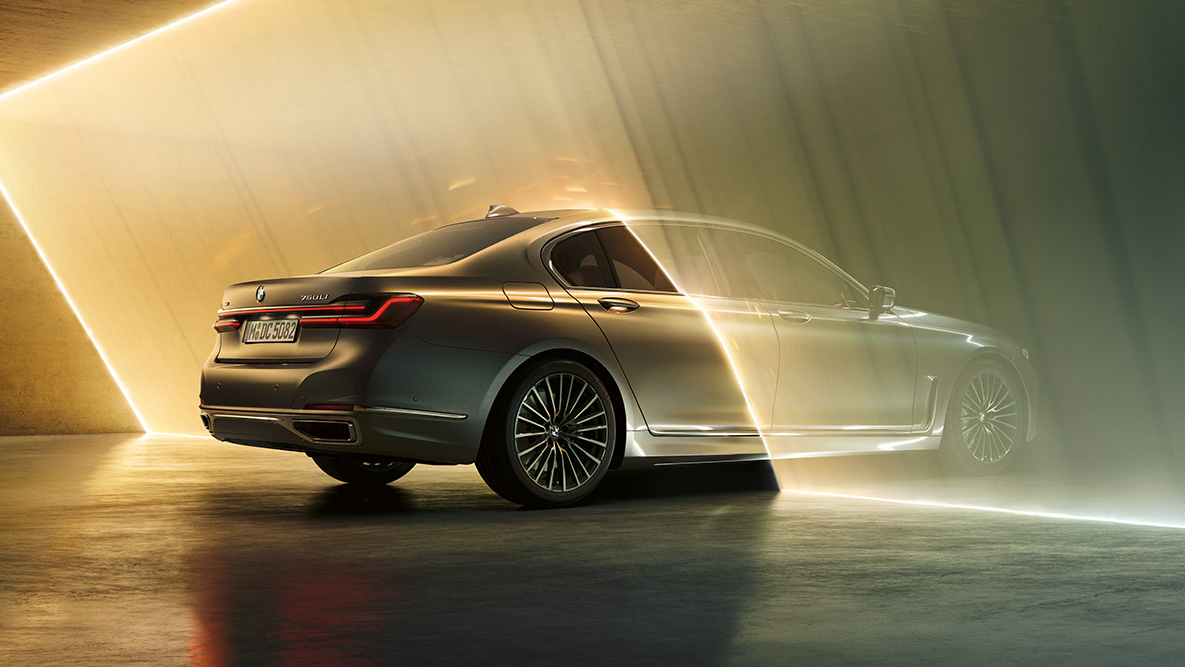 BMW 7 Series Sedan in Bernina Grey 플러그인 하이브리드 G11 BMW 7 Series Sedan in Bernina Grey in three-quarter rear view surrounded by beam of light 플러그인 하이브리드 G11
