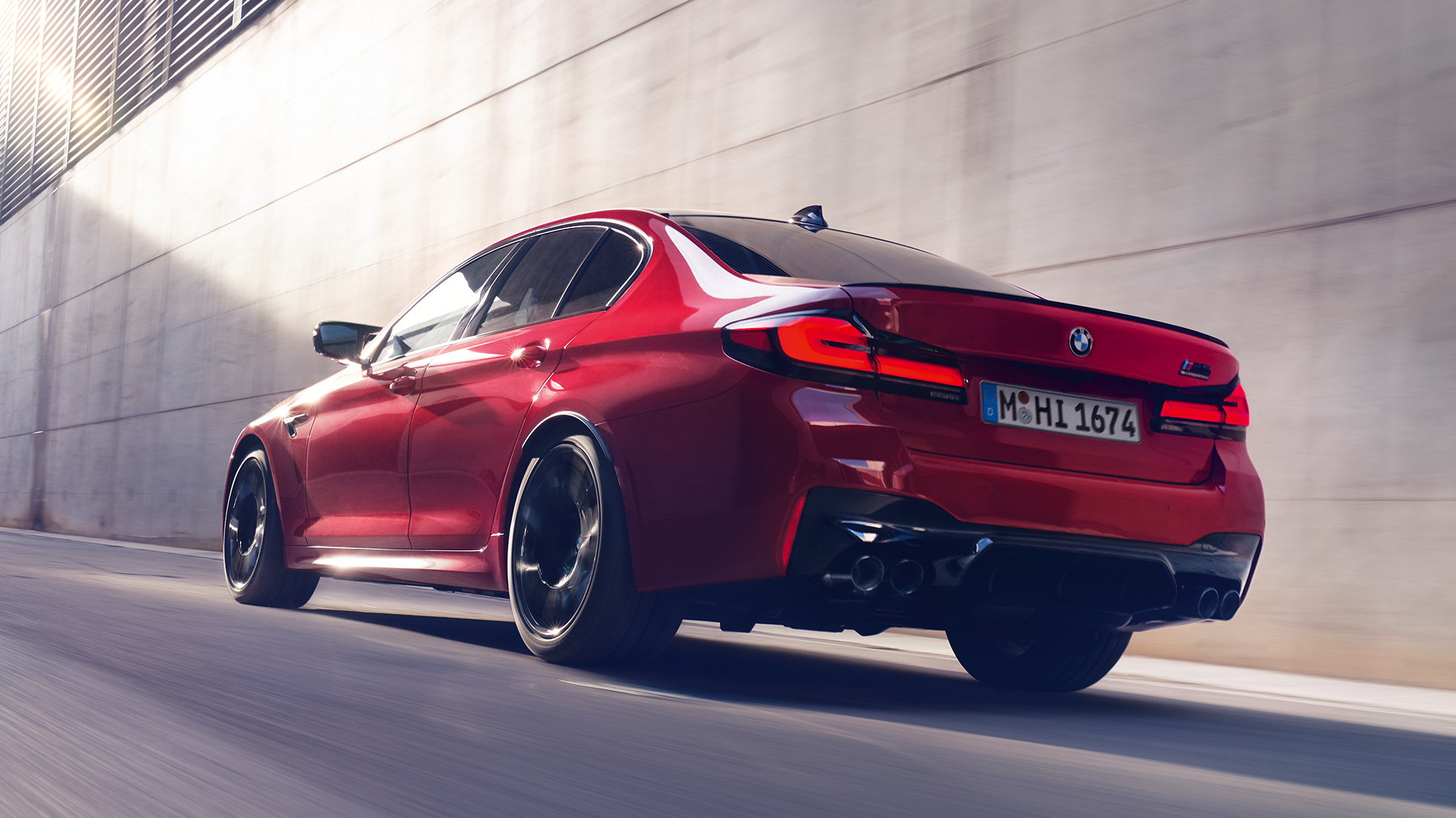 BMW M5 Competition F90 LCI Facelift 2020 three-quarter rear view BMW M5 Competition F90 LCI Facelift 2020 BMW Individual Imola Red three-quarter rear view driving