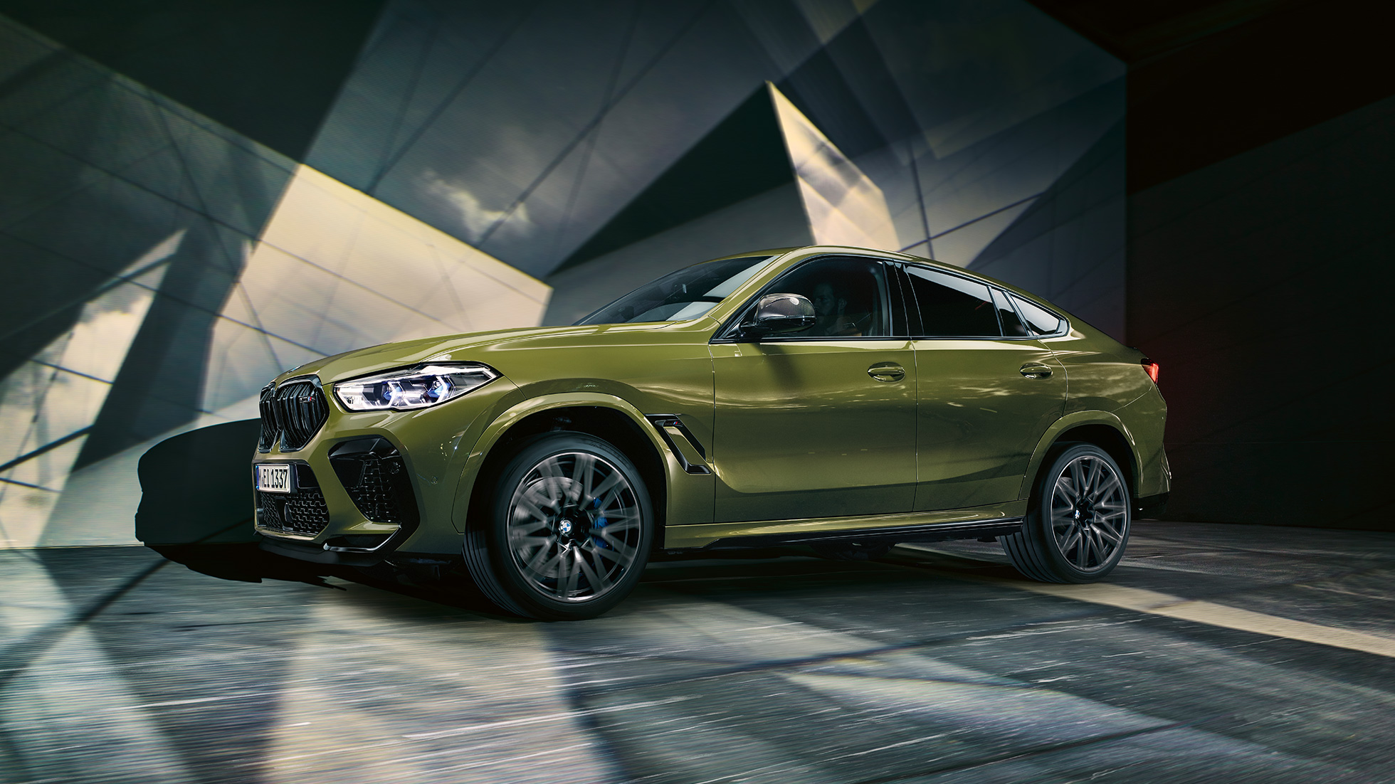 BMW X6 M Competition SUV F96 side view BMW X6 M Competition SUV with M light alloy wheels F96 BMW Individual Special Paint Urban Green side view