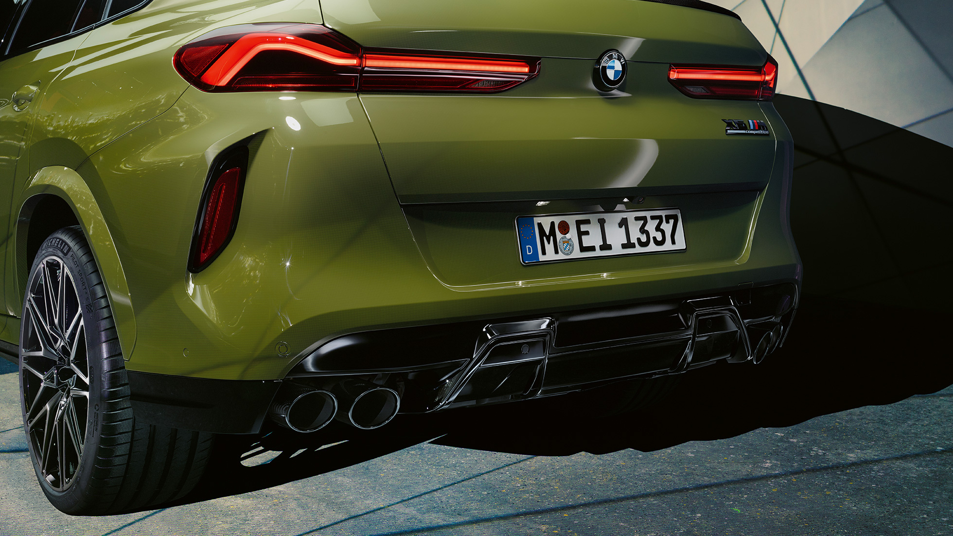 BMW X6 M Competition SUV F96 three-quarter rear view BMW X6 M Competition SUV with M Sport exhaust system F96 BMW Individual Special Paint Urban Green three-quarter rear view