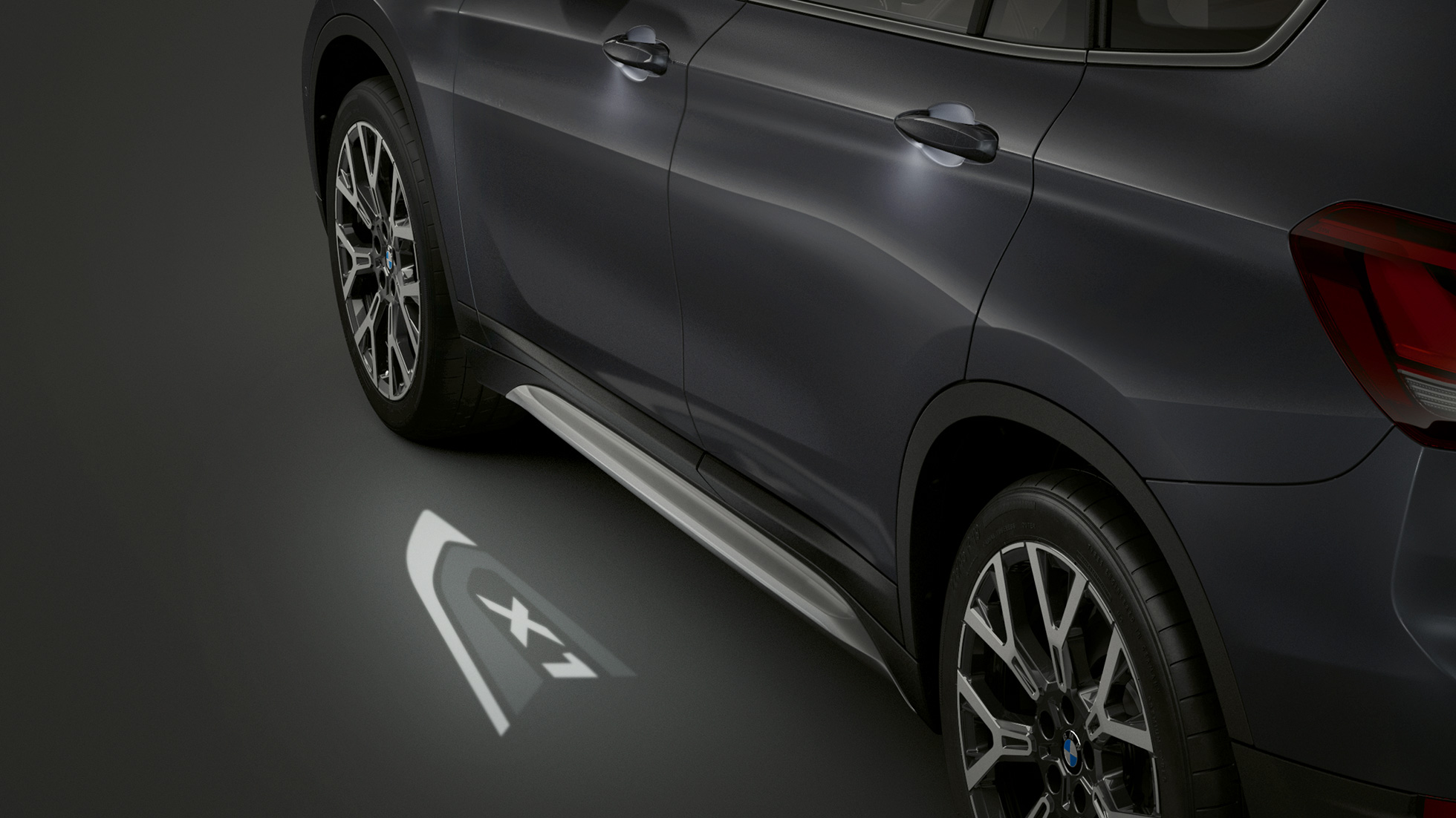 BMW X1 SUV F48, LED-Projection “X1”. BMW X1 SUV F48, side view with focus on LED-Projection “X1”.