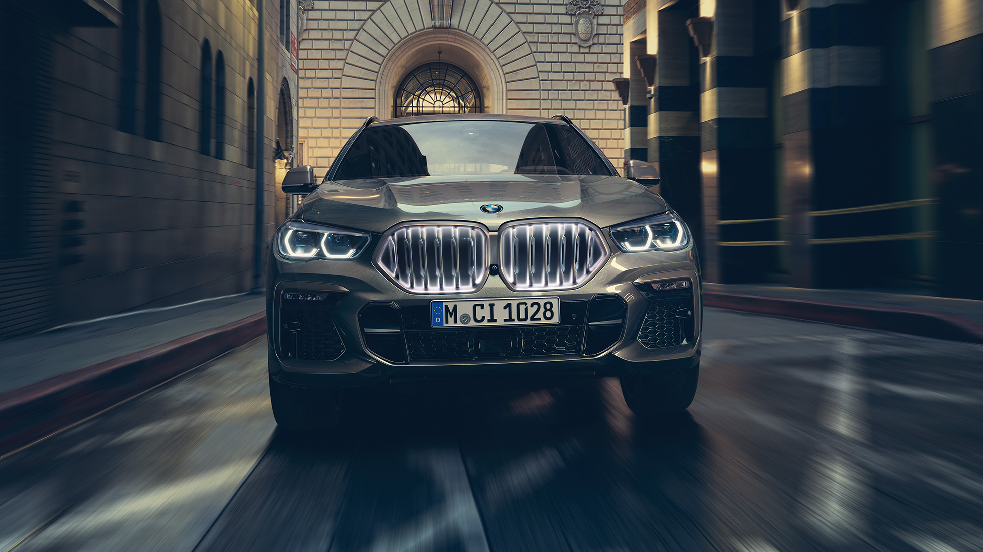 BMW X6 with BMW ‘Iconic Glow’ kidney grille SUV G06. BMW X6 in front view in urban setting SUV G06.