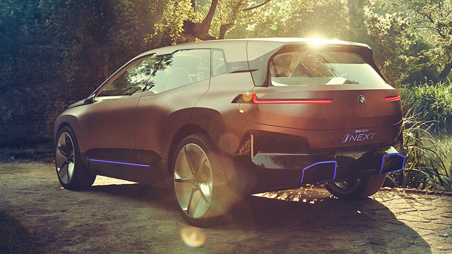 BMW Vision iNEXT in front of a forest BMW Vision iNEXT in front of a forest three-quarter front view