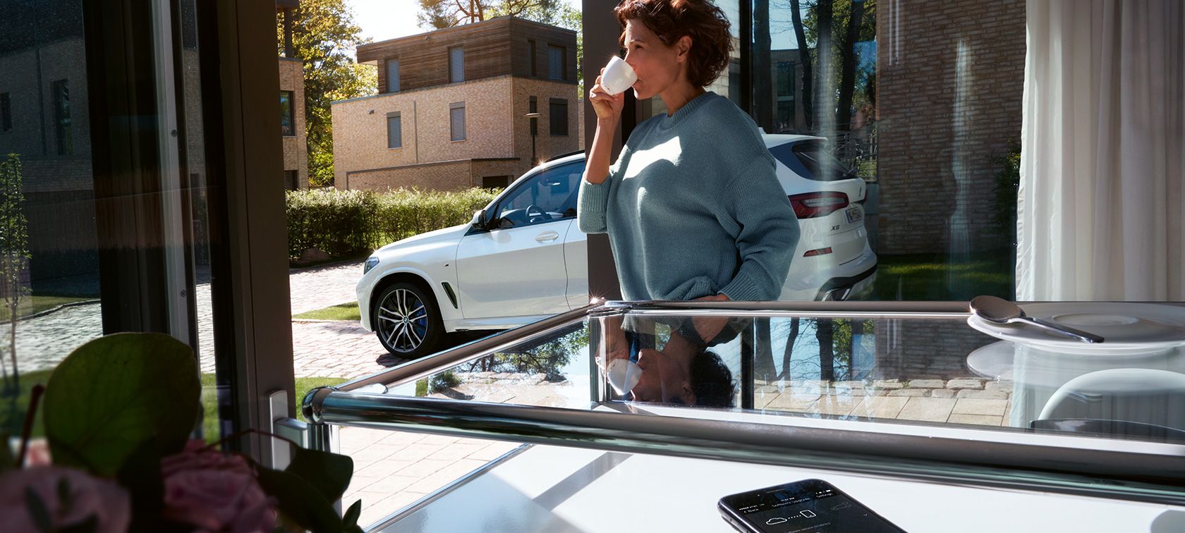 BMW 1 Series Model Sport Line, three-quarter side view F40. BMW 1 Series Model Sport Line in Mineral White metallic, three-quarter side view, driving F40.